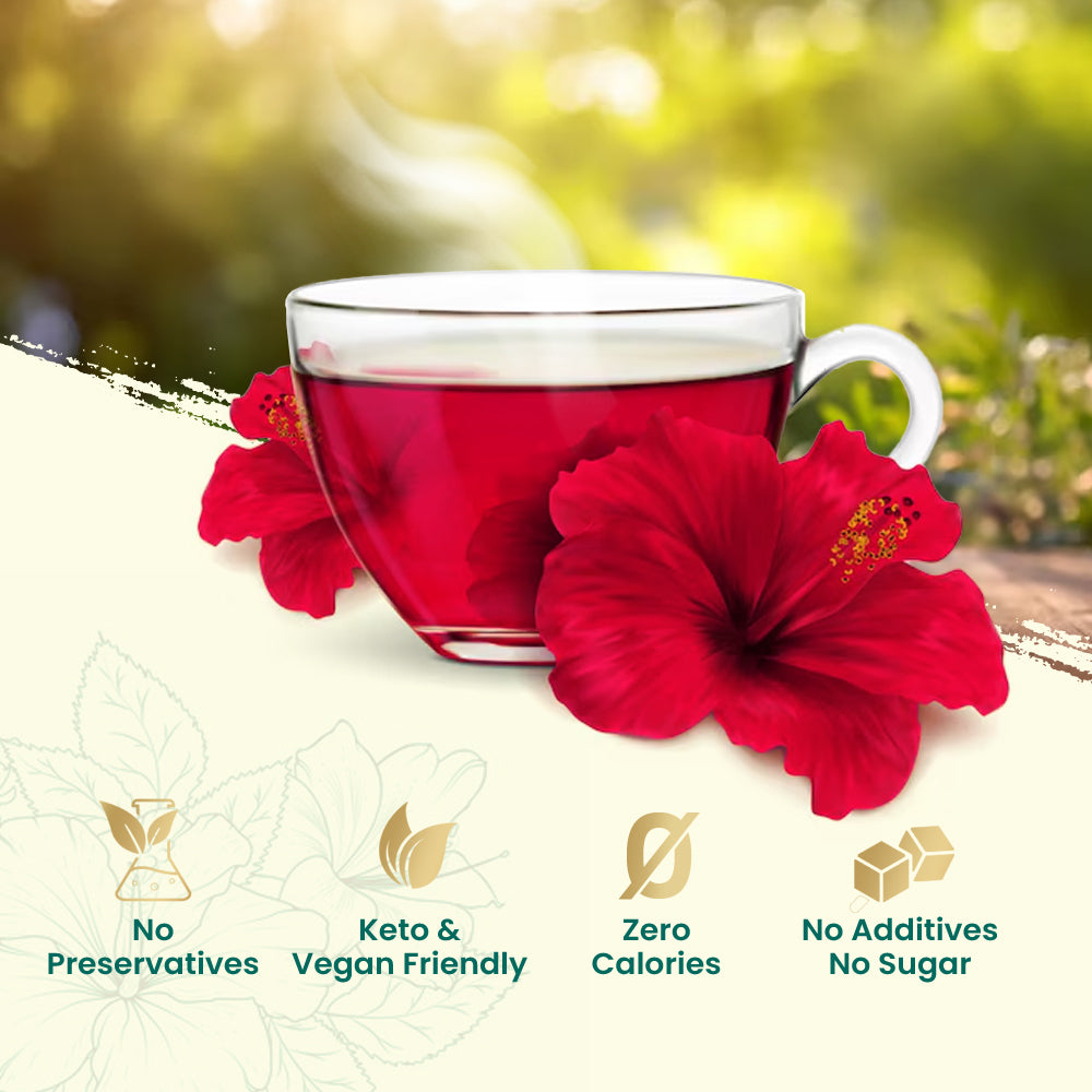 Tea cup with red hibiscus flowers on a blurred natural background.