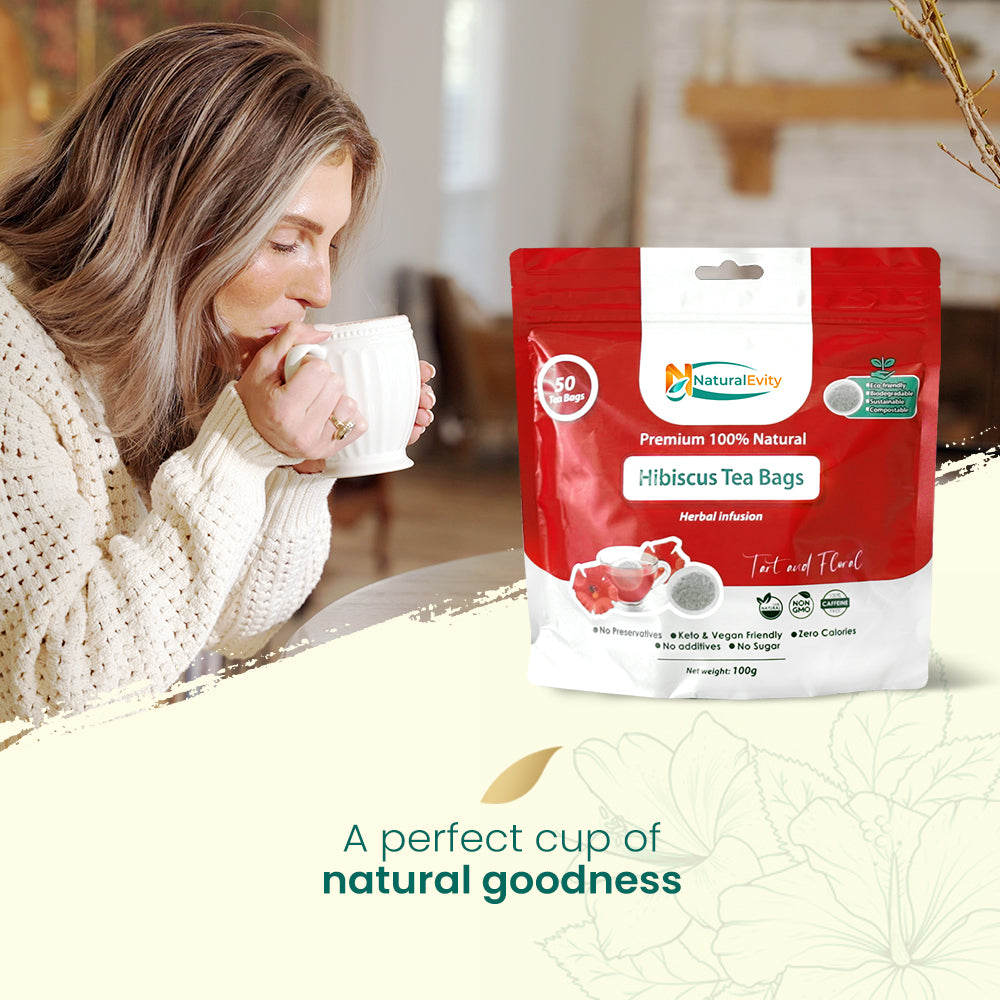 Woman drinking hibiscus tea with a package of Natural Evity Hibiscus Tea Bags in the foreground.